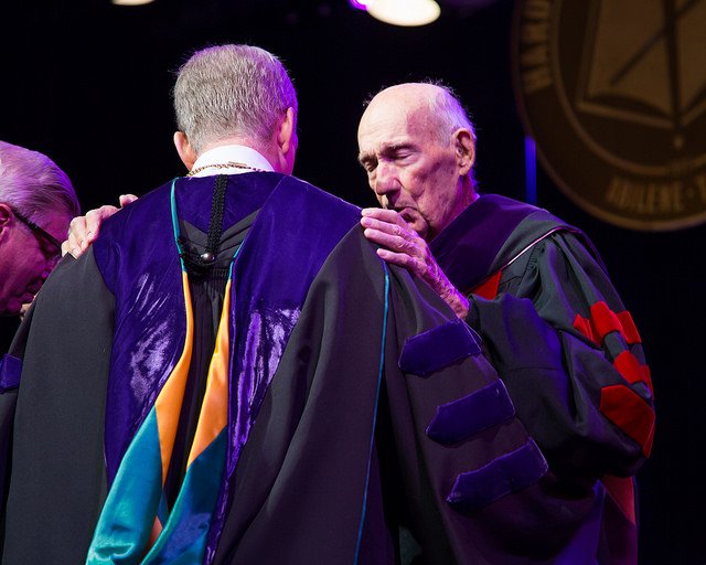 Dr. Fletcher praying over current President Eric Bruntmyer in 2016