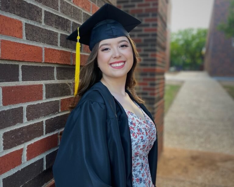 Kylie Mayfield wearing her graduation cap and gown.