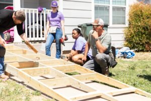 Volunteers building a ramp with boots on the ground.