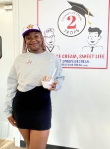 Student writer Charis Ochu poses with her ice cream. 