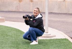 Kacie Eurek with her camera at the football field.