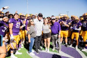 Coach Burleson posing with his family and players