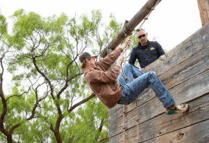 Student and professor at a ropes course for class at the Abilene Police Academy